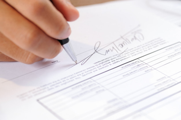 closeup-person-signing-document-with-ball-pen_1262-14867 closeup-person-signing-document-with-ball-pen_1262-14867